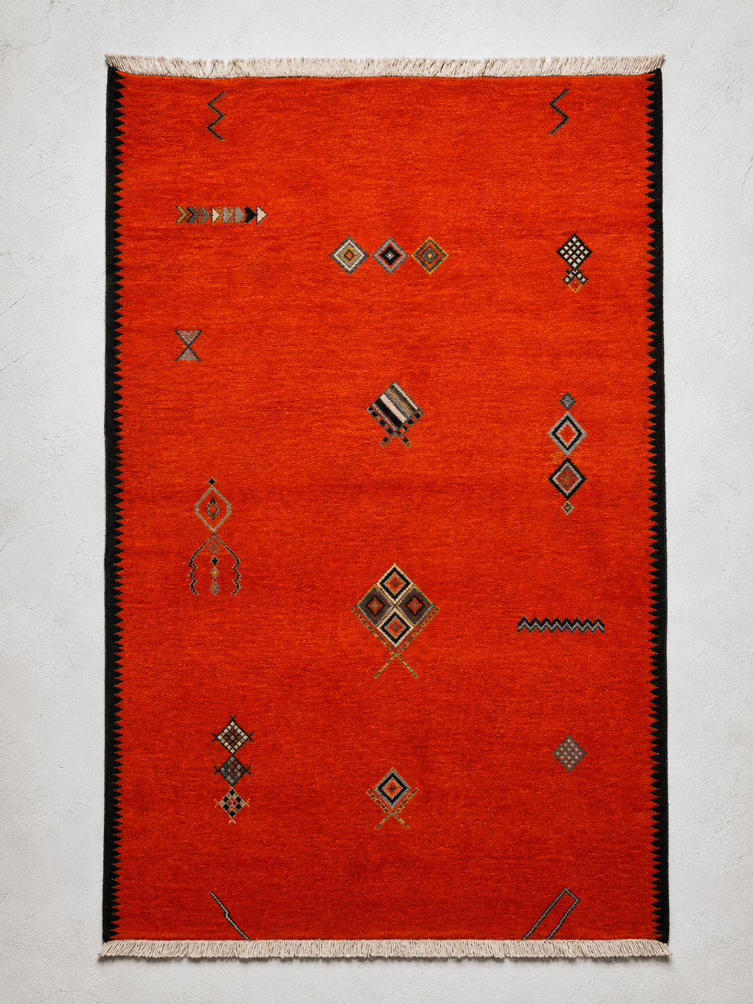 A Boujad rug from the collection — saturated madder and saffron field.